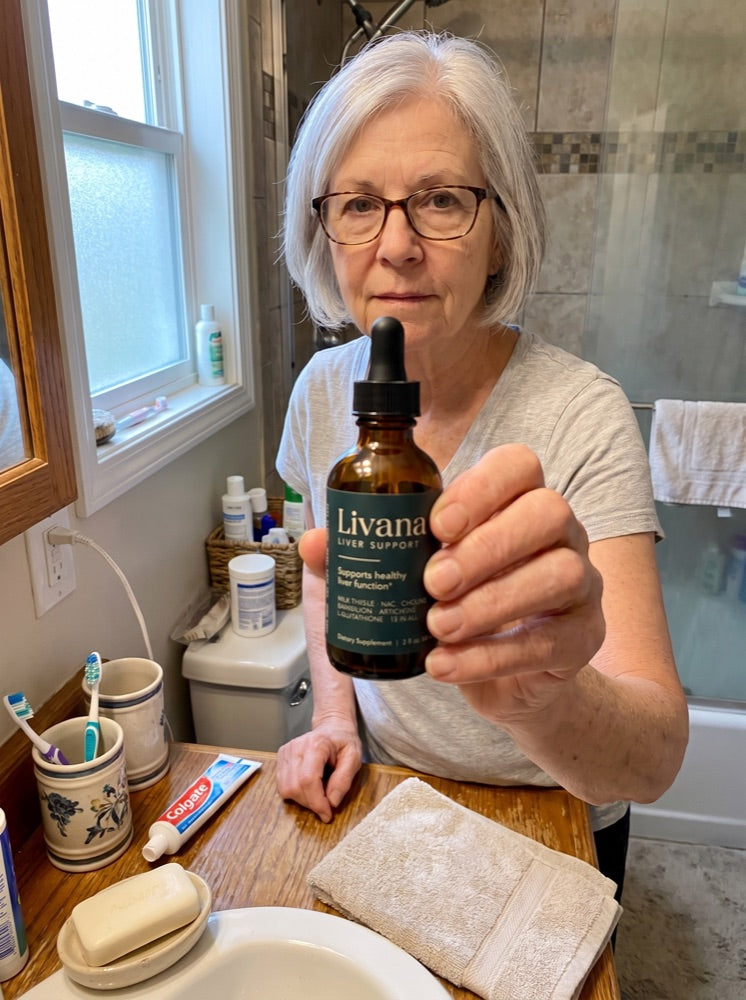 Ellen holding Livana at her bathroom counter