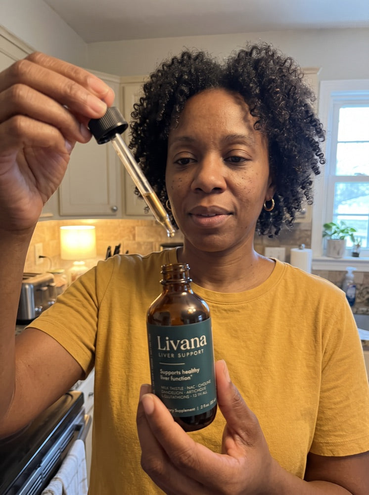 Nicole taking a dose of Livana in her kitchen