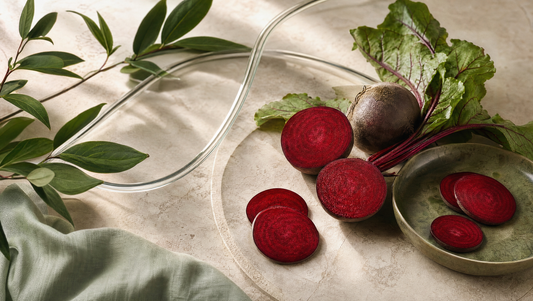 Sliced red beet root and leaves in a botanical still life